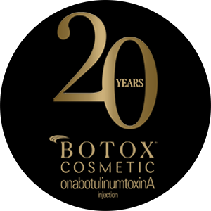 Botox sticker with a black background and gold writing celebrating 20 years